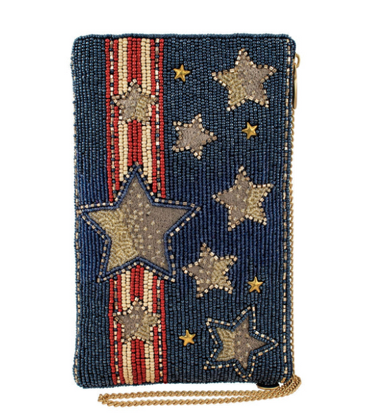 A blue denim color crossbody phone bag with a star and stripe pattern, featuring a gold chain shoulder strap and beadwork embellishments.