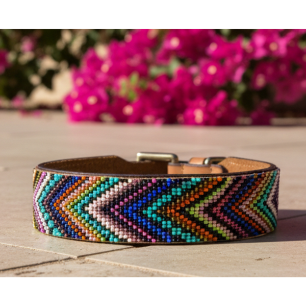 A multicolored dog collar with geometric patterns, made of full grain leather and adorned with glass beads, featuring a strong buckle.