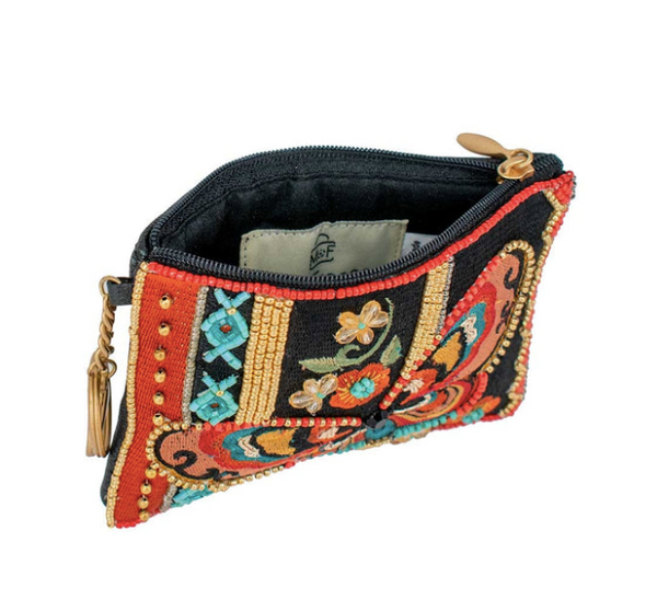 A detailed image of the interior of Journey, a beaded and embroidered coin purse key fob by Mary Frances featuring a butterfly.