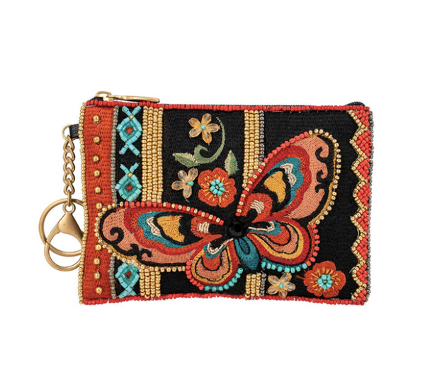 A detailed image of Journey, a beaded and embroidered coin purse by Mary Frances featuring a butterfly.