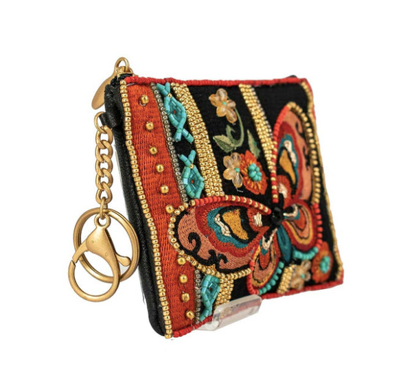 A detailed image of Journey, a beaded and embroidered coin purse key fob by Mary Frances featuring a butterfly.