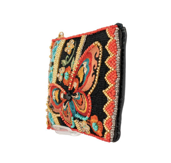 A detailed image of Journey, a beaded and embroidered coin purse key fob by Mary Frances featuring a butterfly.