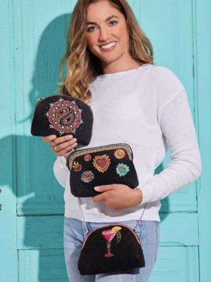 Model showing Mary Frances 3 in 1 Makeupbags