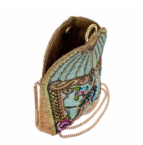 A blue beaded handbag featuring a detailed parrot design with floral patterns and a gold-tone cage-like structure by Mary Frances.