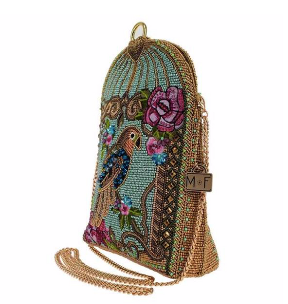 Right side angle of a blue beaded handbag featuring a detailed parrot design with floral patterns and a gold-tone cage-like structure with gold chain strap by Mary Frances.