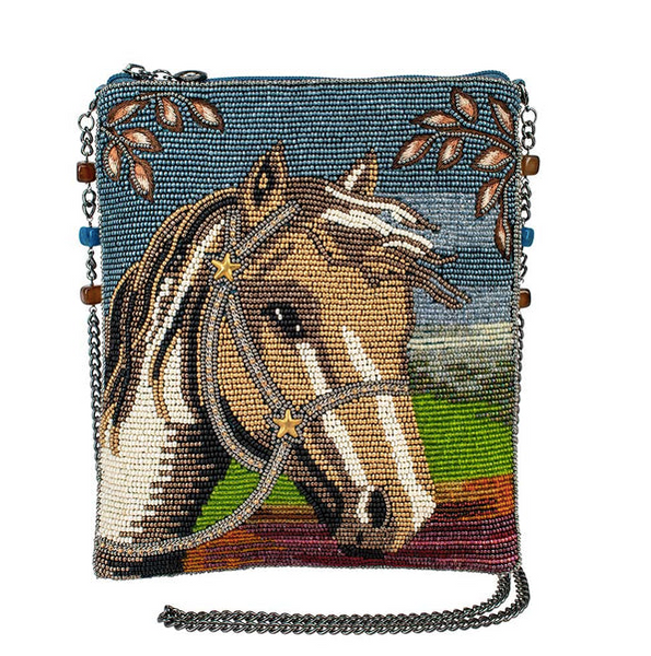 A detailed image of "Spirited" a beaded crossbody handbag by Mary Frances  featuring a horse design and a removable and embellished metal chain